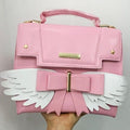 Sac à Main Rose Pâle à Ailes Blanches et Nœud Doré