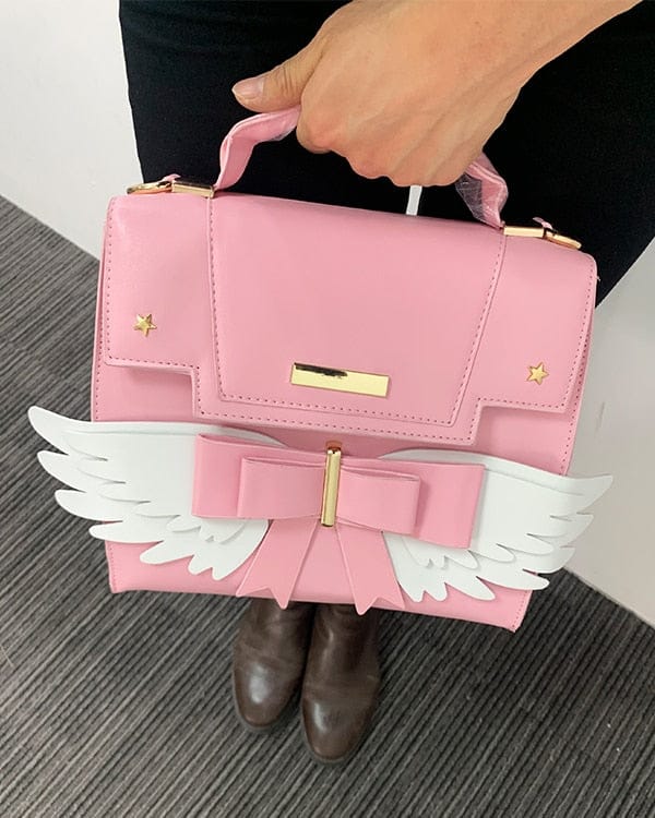 Sac à Main Rose Pâle à Ailes Blanches et Nœud Doré