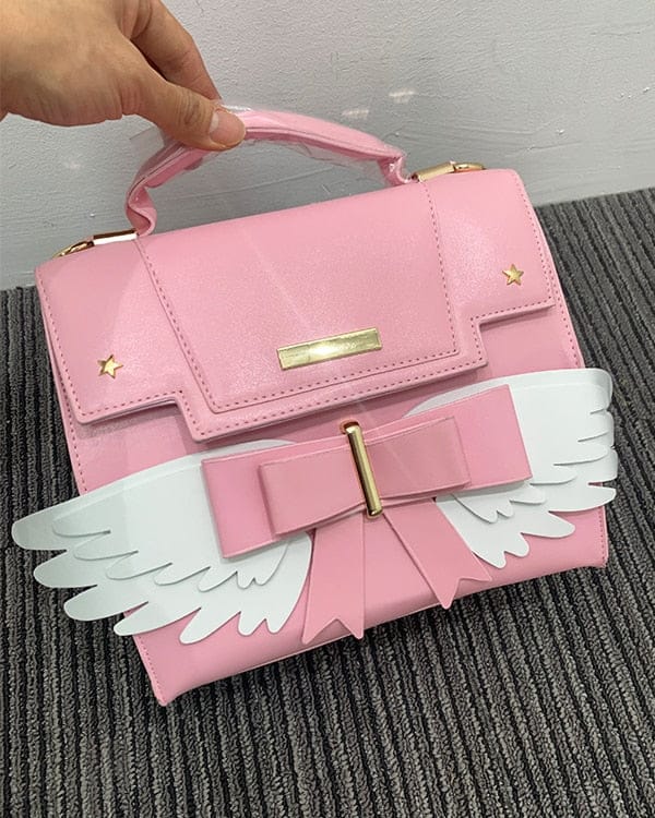 Sac à Main Rose Pâle à Ailes Blanches et Nœud Doré