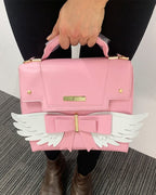 Sac à Main Rose Pâle à Ailes Blanches et Nœud Doré