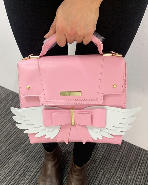 Sac à Main Rose Pâle à Ailes Blanches et Nœud Doré