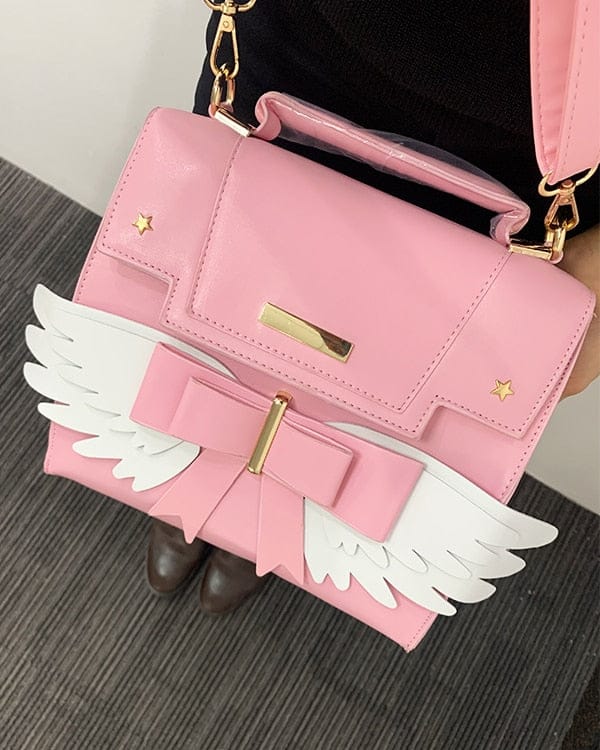Sac à Main Rose Pâle à Ailes Blanches et Nœud Doré