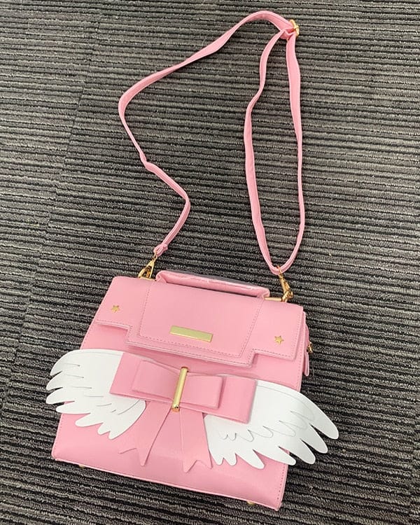 Sac à Main Rose Pâle à Ailes Blanches et Nœud Doré