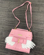 Sac à Main Rose Pâle à Ailes Blanches et Nœud Doré