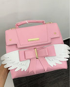 Sac à Main Rose Pâle à Ailes Blanches et Nœud Doré