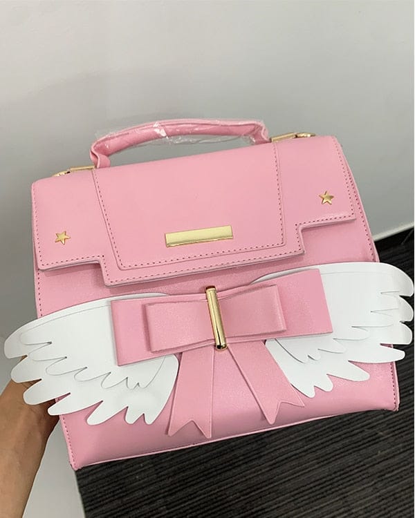 Sac à Main Rose Pâle à Ailes Blanches et Nœud Doré